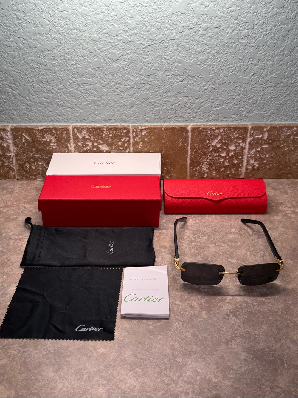 Cartier Men's Black and Gold Rimless Sunglasses